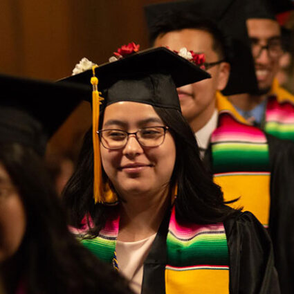 A graduating student at a ceremony for Latinx students