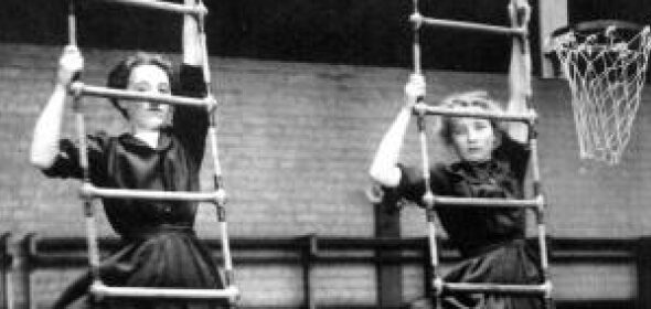 A historical photo of two women climbing ladders beside each other for physical fitness