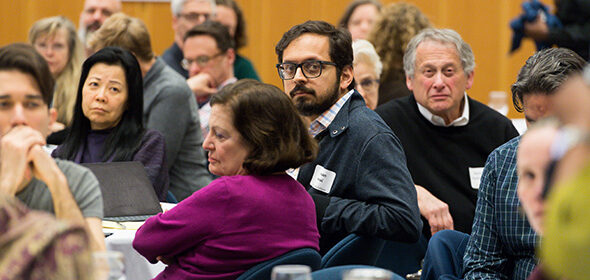A group of faculty members listening to a presentation at the Faculty Community Conversation