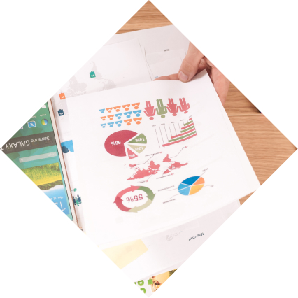 A person holds a sheet with various data visualizations printed on it.