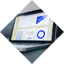 A laptop with a data visualization app showing a variety of graphs